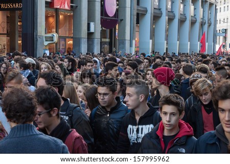 MILAN, ITALY - OCTOBER 11: Secondary school students march in the city streets to protest against money cuts in the public school on OCTOBER 11, 2013 in Milan.