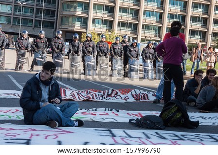 MILAN, ITALY - OCTOBER 11: Secondary school students sit in the city streets to protest against money cuts in the public school on OCTOBER 11, 2013 in Milan.