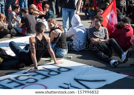 MILAN, ITALY - OCTOBER 11: Secondary school students sit in the city streets to protest against money cuts in the public school on OCTOBER 11, 2013 in Milan.