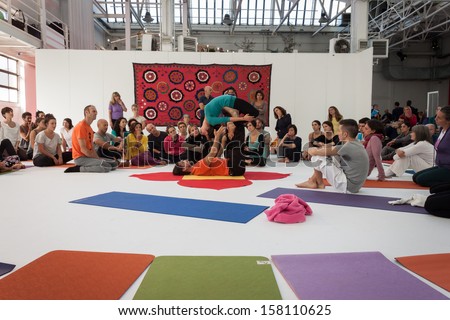 MILAN, ITALY - OCTOBER 11: People take a class at Yoga Festival 2013, event dedicated to yoga, meditation and healthy lifestyle on OCTOBER 11, 2013 in Milan.