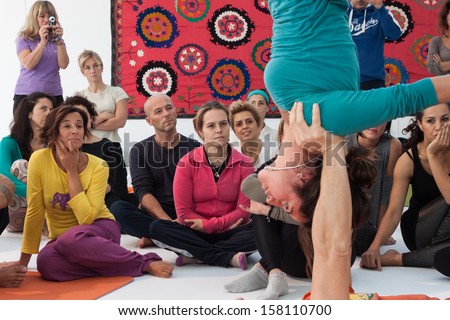 MILAN, ITALY - OCTOBER 11: People take a class at Yoga Festival 2013, event dedicated to yoga, meditation and healthy lifestyle on OCTOBER 11, 2013 in Milan.