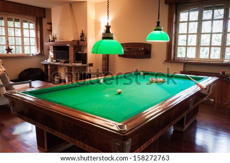 Billiard Table With Mock Tiger Skin Rug On Parquet Floor