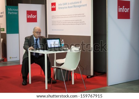 MILAN, ITALY - OCTOBER 23: Businessman works on his computer at Smau, international exhibition of information communications technology on OCTOBER 23, 2013 in Milan.