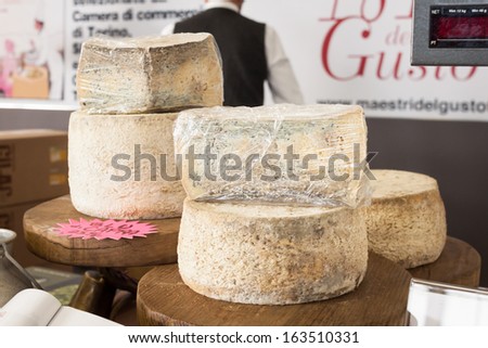 MILAN, ITALY - NOVEMBER 16: Wheels of cheese at Golosaria, important event dedicated to culture and tradition of quality food and wine on NOVEMBER 16, 2013 in Milan.