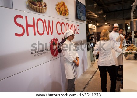 MILAN, ITALY - NOVEMBER 16: Cooks during a show cooking at Golosaria, important event dedicated to culture and tradition of quality food and wine on NOVEMBER 16, 2013 in Milan.
