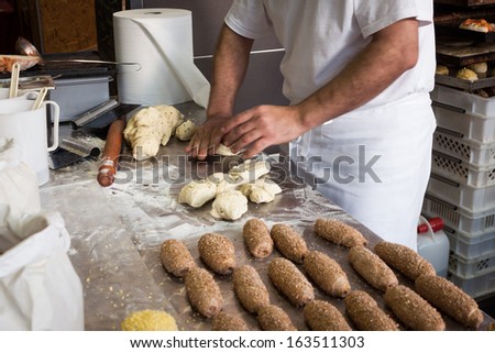 MILAN, ITALY - NOVEMBER 16: Baker prepares bread at Golosaria, important event dedicated to culture and tradition of quality food and wine on NOVEMBER 16, 2013 in Milan.