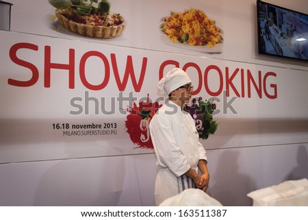 MILAN, ITALY - NOVEMBER 16: Young cook during a show cooking at Golosaria, important event dedicated to culture and tradition of quality food and wine on NOVEMBER 16, 2013 in Milan.