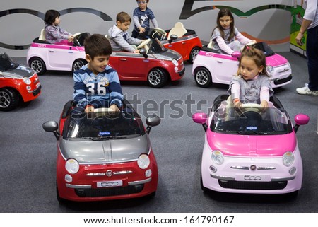 Milan, Italy - November 22: Children Drive Electric Cars At G! Come Giocare, Trade Fair Dedicated To Games, Toys And Children On November 22, 2013 In Milan.