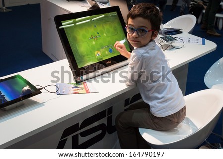 MILAN, ITALY - NOVEMBER 22: Child plays a computer game at G! come giocare, trade fair dedicated to games, toys and children on NOVEMBER 22, 2013 in Milan.