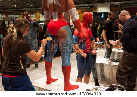 MILAN, ITALY - FEBRUARY 8: Bodybuilders during body painting session at Milano Tattoo Convention, international event dedicated to tattoos, body piercing and body painting on FEBRUARY 8, 2014 in Milan