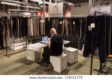 MILAN, ITALY - FEBRUARY 22: Exhibitor in his stand at Mipap, international presentation of women\'s pret-a-porter and accessories on FEBRUARY 22, 2014 in Milan.