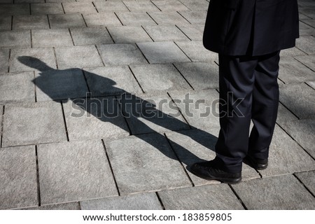 Floor with shadow of a businessman standing