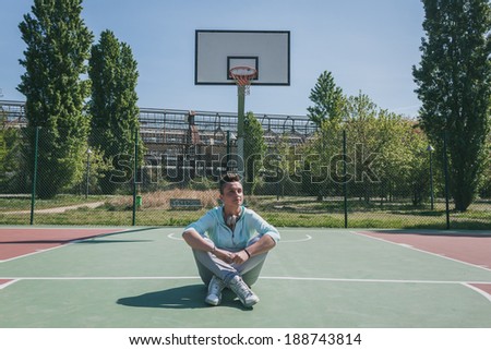Short hair girl with hoodie in a basketball playground