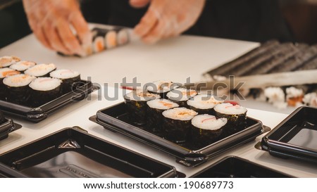 MILAN, ITALY - APRIL 27: Sushi rolls preparation at Orient Festival, event dedicated to Oriental culture and traditions on APRIL 27, 2014 in Milan.