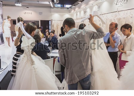 MILAN, ITALY - MAY 23: People visit Si\' Sposaitalia, ultimate exhibition for bridal and formal wear industry on MAY 23, 2014 in Milan.