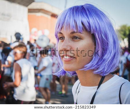 MILAN, ITALY - SEPTEMBER 6: Thousands of people take part in the Color Run event, the funniest and most colorful urban running ever on SEPTEMBER 6, 2014 in Milan.
