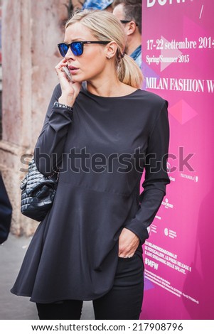 MILAN, ITALY - SEPTEMBER 17: Woman poses outside Byblos fashion shows building for Milan Women\'s Fashion Week on SEPTEMBER 17, 2014 in Milan.