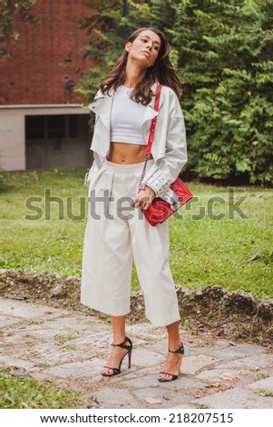 MILAN, ITALY - SEPTEMBER 18: Woman poses outside Costume National fashion shows building for Milan Women\'s Fashion Week on SEPTEMBER 18, 2014 in Milan.