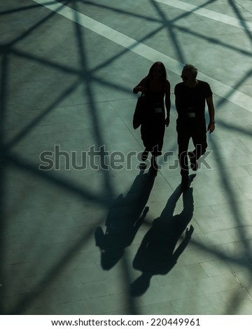 Silhouettes and shadows of people walking in a modern building