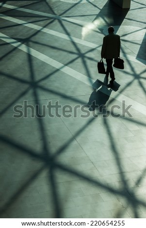Silhouettes and shadows of man walking in a modern building