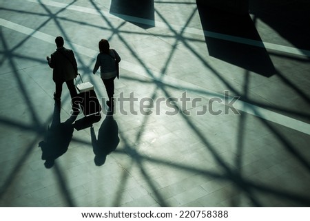 Silhouettes and shadows of people walking in a modern building