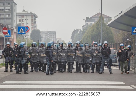MILAN, ITALY - OCTOBER 10: Riot police watches the students protesting against money cuts in the public school on OCTOBER 10, 2014 in Milan.