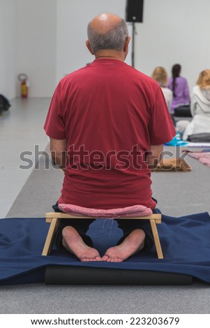MILAN, ITALY - OCTOBER 10: Man takes a class at Yoga Festival, event dedicated to yoga, meditation and healthy lifestyle on OCTOBER 10, 2014 in Milan.