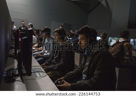 MILAN, ITALY - OCTOBER 24: People play at Games Week 2014, event dedicated to video games and electronic entertainment on OCTOBER 24, 2014 in Milan.