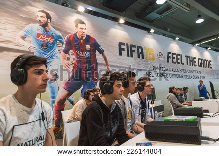 MILAN, ITALY - OCTOBER 24: Guys play at Games Week 2014, event dedicated to video games and electronic entertainment on OCTOBER 24, 2014 in Milan.