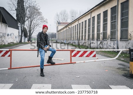 Punk guy with beanie posing in the city streets