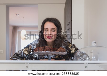 Beautiful young brunette with long hair posing with brownies