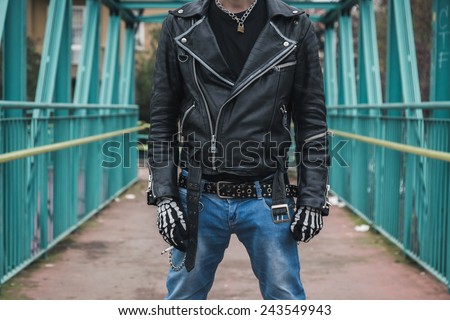 Punk guy with cigarette posing in the city streets