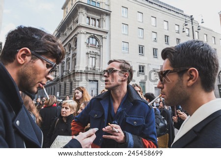 MILAN, ITALY - JANUARY 18: People gather outside Ferragamo fashion show building for Milan Men\'s Fashion Week on JANUARY 18, 2015 in Milan.