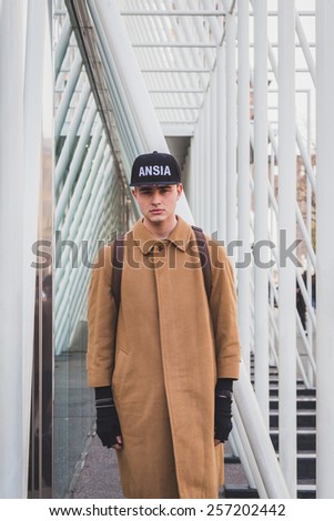 MILAN, ITALY - FEBRUARY 28: Man poses outside Jil Sander fashion show building for Milan Women\'s Fashion Week on FEBRUARY 28, 2015  in Milan.