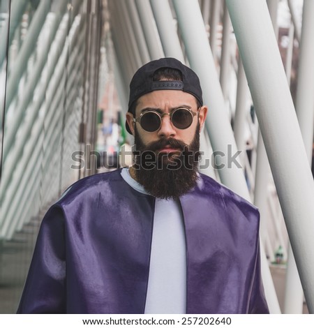MILAN, ITALY - FEBRUARY 28: Man poses outside Jil Sander fashion show building for Milan Women\'s Fashion Week on FEBRUARY 28, 2015  in Milan.