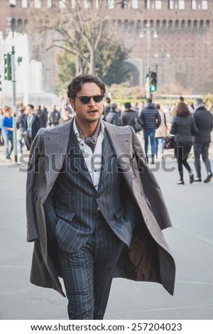 MILAN, ITALY - FEBRUARY 28: Man poses outside Jil Sander fashion show building for Milan Women's Fashion Week on FEBRUARY 28, 2015  in Milan.