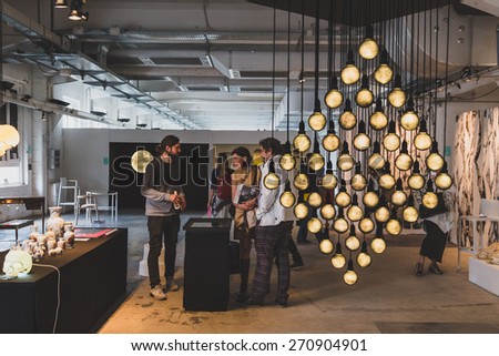MILAN, ITALY - APRIL 18: People visit Fuorisalone, series of important and interesting events all around the town during Milan Design Week on APRIL 18, 2015 in Milan.
