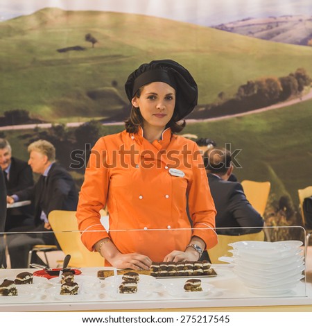 MILAN, ITALY - MAY 4: Pretty girl working at Tuttofood, world food exhibition on MAY 4, 2015 in Milan.