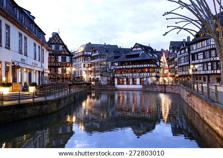 Medieval cityscape of Rhineland black and white timber-framed buildings in the Petite-France district alongside the river Ill at twilight - France, Alsace region, Strasbourg
