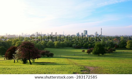 Breath-taking panoramic scenic view of London cityscape seen from beautiful Primrose Hill in St. Regents park on a sunny summer morning