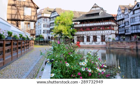 Medieval cityscape of Rhineland black and white timber-framed buildings in the Petite-France district alongside the river Ill on sunny summer day. France, Alsace region, Strasbourg