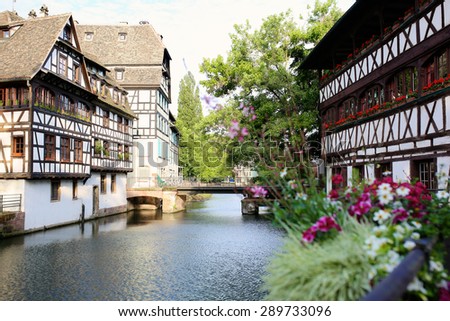 Medieval cityscape of Rhineland black and white timber-framed buildings in the Petite-France district alongside the river Ill on sunny summer day - France, Alsace region, Strasbourg