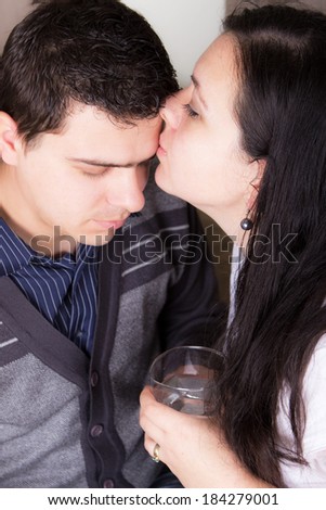 Tender wife kissing husband\'s forehead to check fever