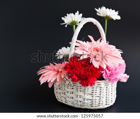 Basket of flowers is a gift for someone.