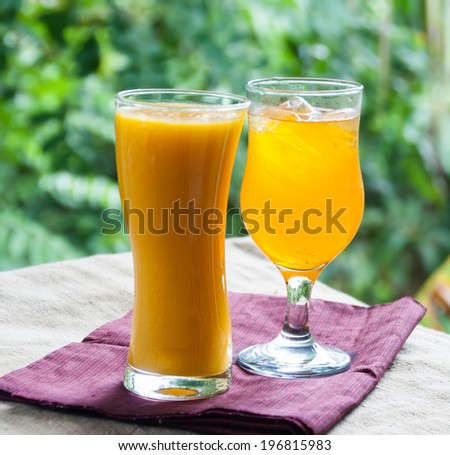 Smoothie mango juice and ice orange juice
