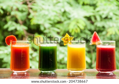 Four glasses of colorful drink of fruit and vegetable juice for good health