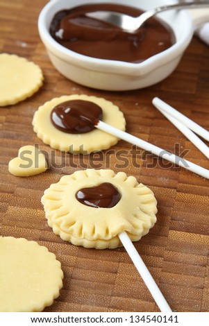 Process of baking homemade shortbread cookies pops with chocolate