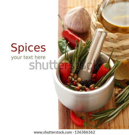 Fresh rosemary herb and red pepper in metal mortar with pestle, olive oil and chinese garlic with sample text