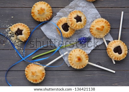 Homemade shortbread cookies on a stick on wooden background