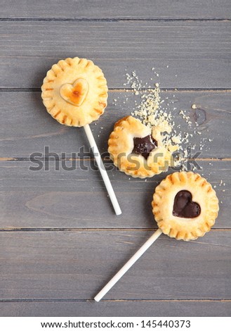 Homemade shortbread cookies on a stick on wooden background